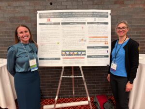 Kristen Syrett and Misha Becker in front of their poster at BUCLD 50
