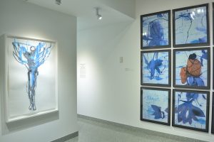 Installation view of watercolor and six photographs.