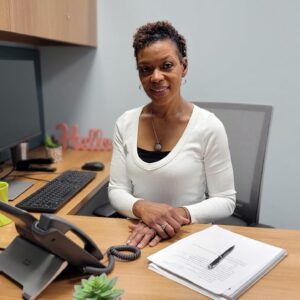 A woman sitting at an office desk.