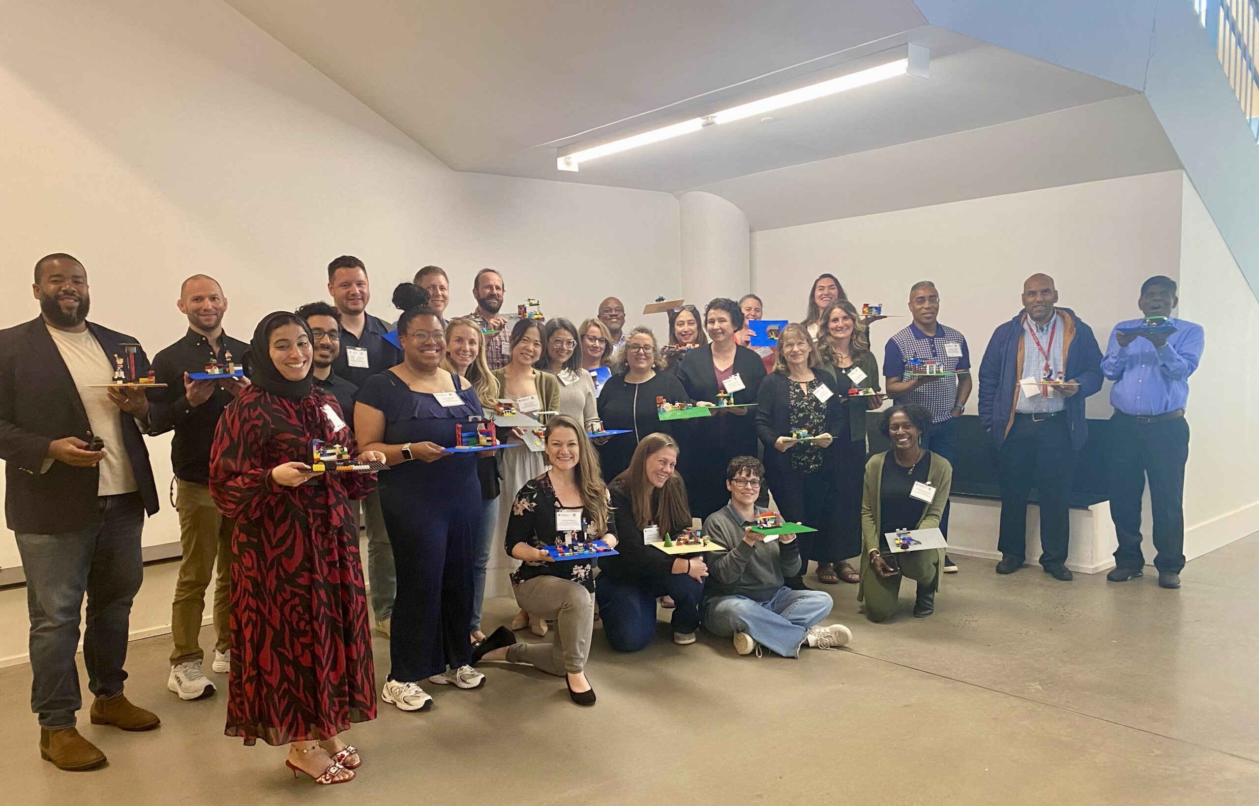 May 2025 Course Design Institute participants showcase their LEGO models, which symbolize their course design visions.