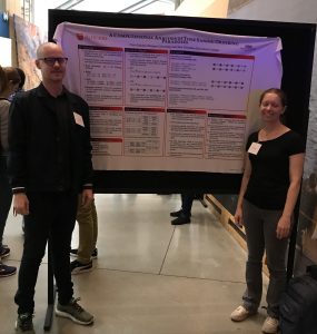 Chris and Jane in front of their poster