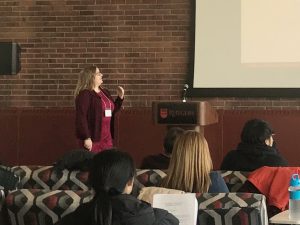 Natasha in front of powerpoint