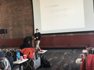 Adam in front of powerpoint