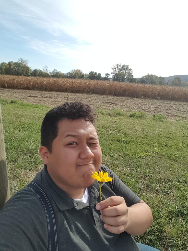 Gerard sniffing a daisy