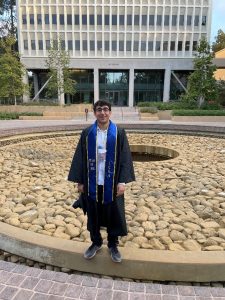 A photo of Aidan Sharma in graduation regalia