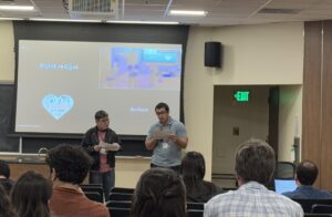 Picture of Aidan and Merlin presenting at Tu+ 2025