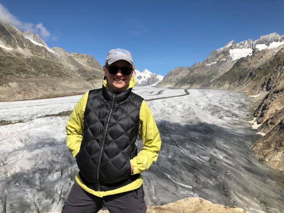 Dr. Adamo standing on a glacier in Switzerland.