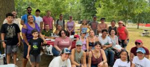 Group of Rutgers University - Latino/a/Hispanic Affinity Group members celebrating one year anniversary in public park.