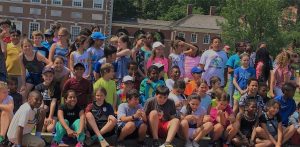 A diverse group of dozens of children of about 10 years old.