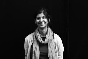 Headshot of Jayati Narain stading in front of black background