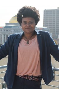 Headshot of Nakeefa Garay with a golden-domed building in the background.