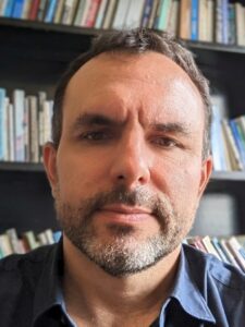 Headshot of Sean T. Mitchell in front of a bookshelf.