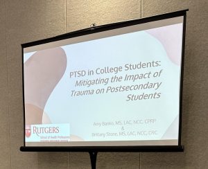 Photo of a projector with the presentation, PTSD in College Students displayed.